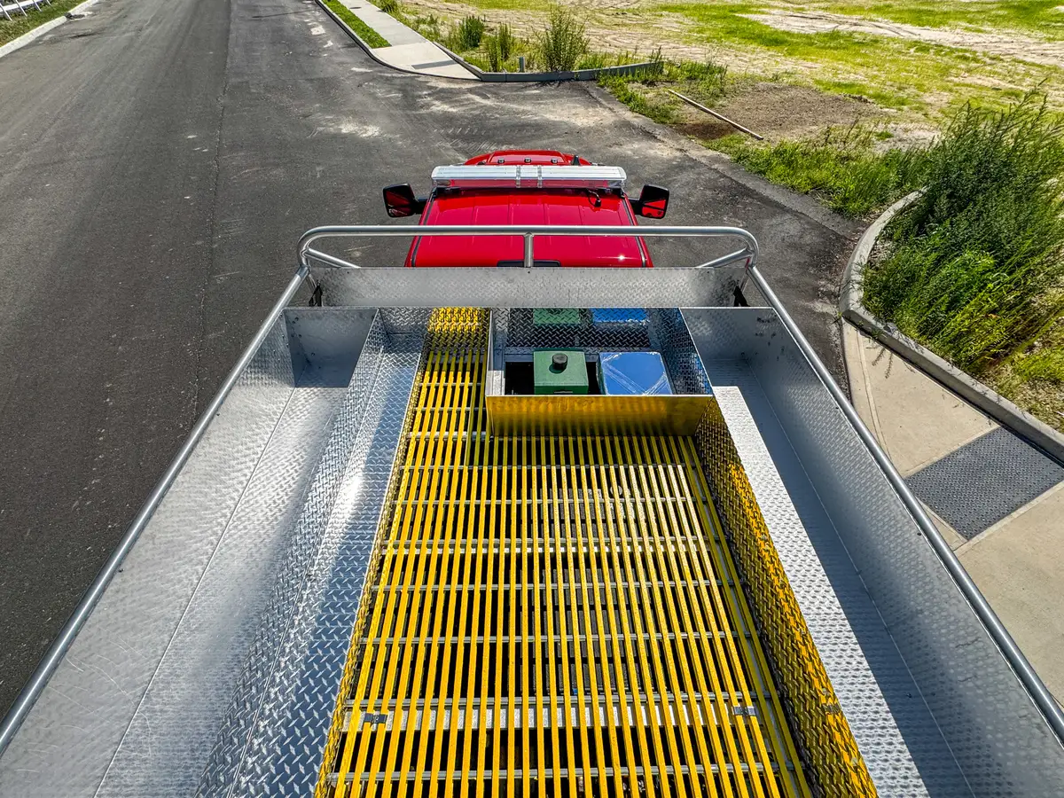 Top deck elevated view showing grating, center hatch, and rear rails.